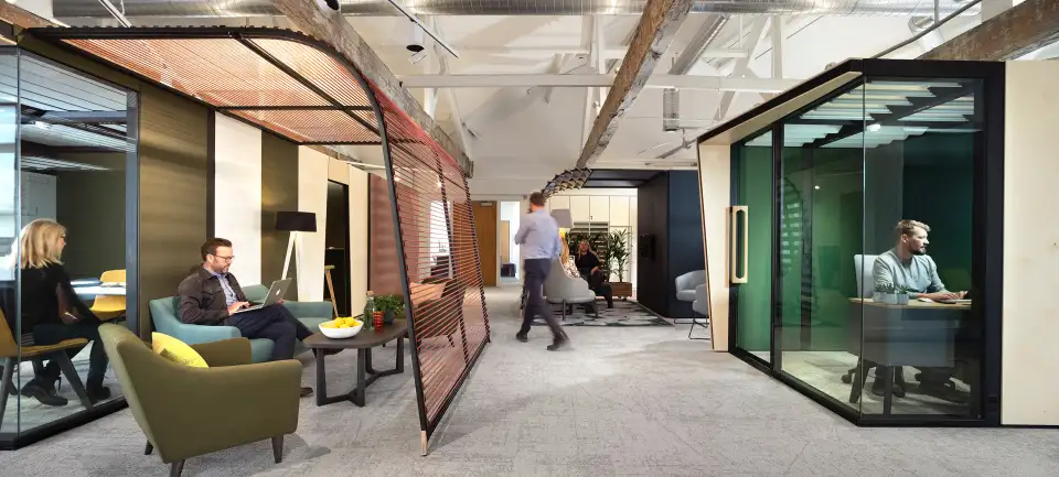 Office breakout area with a curved timber archway and meeting booths