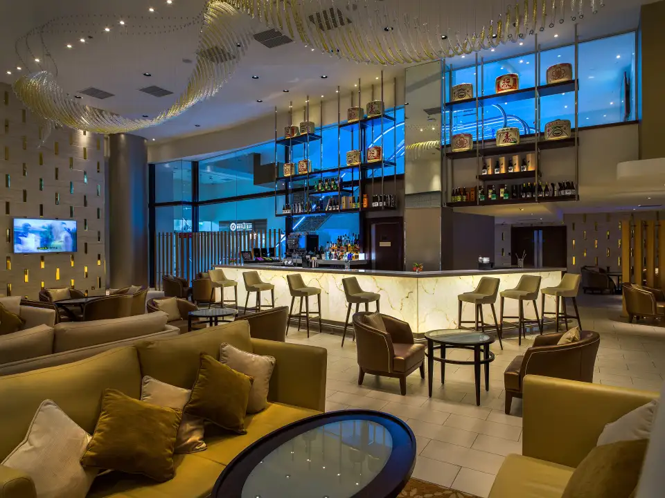 Hotel lounge bar with sofas, armchairs and a curved bar