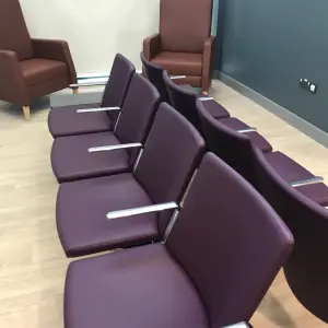 Purple high-back chairs in a waiting area at The Wilson Health Centre