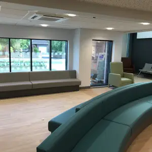 Waiting area with curved teal bench seating at The Wilson Health Centre