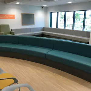Curved teal waiting room seating and chairs at The Wilson Health Centre